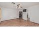 Spacious bedroom with wood-look flooring, ceiling fan, and access to ensuite bath at 4207 W Soft Wind Dr, Glendale, AZ 85310