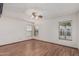Well-lit bedroom offers wood-look flooring, neutral paint and a ceiling fan at 4207 W Soft Wind Dr, Glendale, AZ 85310