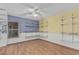 Bedroom with wood floors, built-in shelving, and a ceiling fan at 4207 W Soft Wind Dr, Glendale, AZ 85310