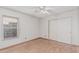 Bedroom features wood-style floors, window, and a closet at 4207 W Soft Wind Dr, Glendale, AZ 85310