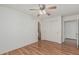 Bedroom featuring wood floors, ceiling fan, closet and ensuite bathroom at 4207 W Soft Wind Dr, Glendale, AZ 85310