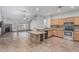Bright open-plan kitchen features tile flooring, granite counters and a large island with seating at 4207 W Soft Wind Dr, Glendale, AZ 85310