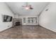 Stylish living room with tile floors, a brick fireplace, a ceiling fan and large windows at 4207 W Soft Wind Dr, Glendale, AZ 85310