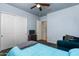Comfortable bedroom with sliding closet doors, TV, and blue bedspread at 4234 E Narrowleaf Dr, Gilbert, AZ 85298