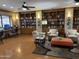 Inviting community library with comfortable seating, a computer, and extensive built-in bookshelves at 4234 E Narrowleaf Dr, Gilbert, AZ 85298