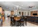 Bright dining area with chandelier and wood table open to the kitchen and living area at 4234 E Narrowleaf Dr, Gilbert, AZ 85298