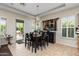 Dining area featuring tile flooring, modern chandelier, and seamless flow to outdoor patio at 4234 E Narrowleaf Dr, Gilbert, AZ 85298