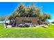 Beautiful community entrance with lush landscaping, mature trees, and serene water feature with a Trilogy sign at 4234 E Narrowleaf Dr, Gilbert, AZ 85298