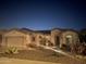 Inviting front exterior featuring desert landscaping, outdoor lighting, and a charming water fountain at 4234 E Narrowleaf Dr, Gilbert, AZ 85298
