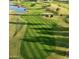 Aerial view of a well-maintained golf course with sand traps and manicured greens at 4234 E Narrowleaf Dr, Gilbert, AZ 85298