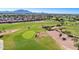 Scenic aerial view of a golf course with desert landscaping and mountain views in the distance at 4234 E Narrowleaf Dr, Gilbert, AZ 85298