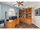 Home office with custom built-in bookshelves and storage, plus a ceiling fan at 4234 E Narrowleaf Dr, Gilbert, AZ 85298