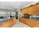 Bright kitchen featuring granite countertops, wood cabinetry, and views into the dining area at 4234 E Narrowleaf Dr, Gilbert, AZ 85298