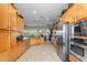 Spacious kitchen with stainless steel appliances, wooden cabinets, and ample counter space at 4234 E Narrowleaf Dr, Gilbert, AZ 85298