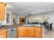 Open kitchen showcasing granite countertops, wooden cabinetry, and stainless steel dishwasher at 4234 E Narrowleaf Dr, Gilbert, AZ 85298