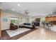 Open-concept living room featuring tile flooring, large windows, coffered ceiling, and comfortable seating at 4234 E Narrowleaf Dr, Gilbert, AZ 85298