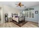 Bright main bedroom with ceiling fan, wood floors, and large windows at 4234 E Narrowleaf Dr, Gilbert, AZ 85298