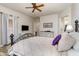 This main bedroom features a ceiling fan, neutral paint, and wood floors at 4234 E Narrowleaf Dr, Gilbert, AZ 85298
