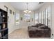 Bright sitting room features tile floors and multiple windows with shutters for natural light at 4234 E Narrowleaf Dr, Gilbert, AZ 85298