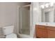 Bathroom featuring shower stall with glass door, toilet, and vanity sink at 4617 E Culver St, Phoenix, AZ 85008