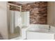 Modern bathroom with large soaking tub, shower stall with glass door, and decorative accent wall at 4617 E Culver St, Phoenix, AZ 85008