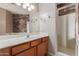 Bathroom featuring decorative accent wall, tile floors, shower stall, and vanity sink at 4617 E Culver St, Phoenix, AZ 85008