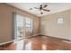 Bright bedroom featuring wood floors, neutral walls, ceiling fan, and large windows with neighborhood views at 4617 E Culver St, Phoenix, AZ 85008