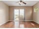 Bright, spacious bedroom featuring neutral walls, ceiling fan, wood floors, and large window at 4617 E Culver St, Phoenix, AZ 85008