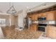 A kitchen featuring granite counters, stainless steel appliances, and custom wood cabinetry at 4617 E Culver St, Phoenix, AZ 85008