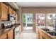 Modern kitchen with stainless steel appliances, stone accents, and natural light-filled windows at 4617 E Culver St, Phoenix, AZ 85008