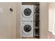 Stackable washer and dryer set in a laundry closet with wire shelves at 4617 E Culver St, Phoenix, AZ 85008