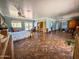 Large bedroom with tile flooring, a ceiling fan, a seating area, and good natural light at 4621 E Desert Forest Trl, Cave Creek, AZ 85331