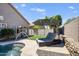 Relaxing backyard with a sparkling pool, rock waterfall feature, green lawn and comfortable lounge chairs at 4762 E White Aster St, Phoenix, AZ 85044