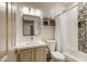 Well-lit bathroom with a modern vanity, shelving, and a shower-tub combination at 4762 E White Aster St, Phoenix, AZ 85044