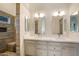 Bright bathroom boasts a dual vanity, neutral tile and lots of light at 4762 E White Aster St, Phoenix, AZ 85044