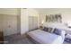 Cozy bedroom with soft carpet, neutral decor, and a modern bed frame at 4762 E White Aster St, Phoenix, AZ 85044