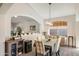 Elegant dining room with stylish chandelier, adjacent to the kitchen and living areas at 4762 E White Aster St, Phoenix, AZ 85044