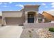 Charming home featuring desert landscaping, a covered porch and a two-car garage in a sunny neighborhood at 4762 E White Aster St, Phoenix, AZ 85044