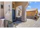 Covered porch area featuring comfortable seating, an outdoor fireplace and stone paving at 4762 E White Aster St, Phoenix, AZ 85044