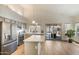 Bright kitchen features stainless steel appliances, a center island, and sliding glass doors to the pool at 4762 E White Aster St, Phoenix, AZ 85044