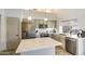 Modern kitchen with stainless steel appliances, a large island, and elegant pendant lighting at 4762 E White Aster St, Phoenix, AZ 85044