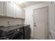 Spacious laundry room with modern LG washer and dryer and ample storage at 4762 E White Aster St, Phoenix, AZ 85044