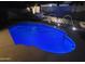 Inviting swimming pool at night with lighted water fountains, creating a relaxing ambiance at 4762 E White Aster St, Phoenix, AZ 85044
