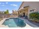 Inviting backyard oasis featuring a sparkling pool, built-in grill, covered patio, and comfortable outdoor seating at 4762 E White Aster St, Phoenix, AZ 85044