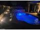Inviting swimming pool at night with lighted water fountains, creating a relaxing ambiance at 4762 E White Aster St, Phoenix, AZ 85044