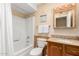 Cozy bathroom features a tub/shower combo, neutral color palette, and framed vanity mirror at 5037 N 81St St, Scottsdale, AZ 85250