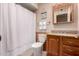 Functional bathroom features an oak vanity, sink, toilet, and a shower at 5037 N 81St St, Scottsdale, AZ 85250