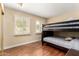 Bedroom featuring a bunk bed with two windows and wood flooring at 5037 N 81St St, Scottsdale, AZ 85250