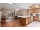 Open kitchen and dining area featuring an island, wood cabinets, and sliding door access to the patio at 5037 N 81St St, Scottsdale, AZ 85250