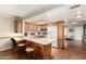 Well-lit kitchen features wood cabinets, stainless appliances, and a breakfast bar with seating at 5037 N 81St St, Scottsdale, AZ 85250